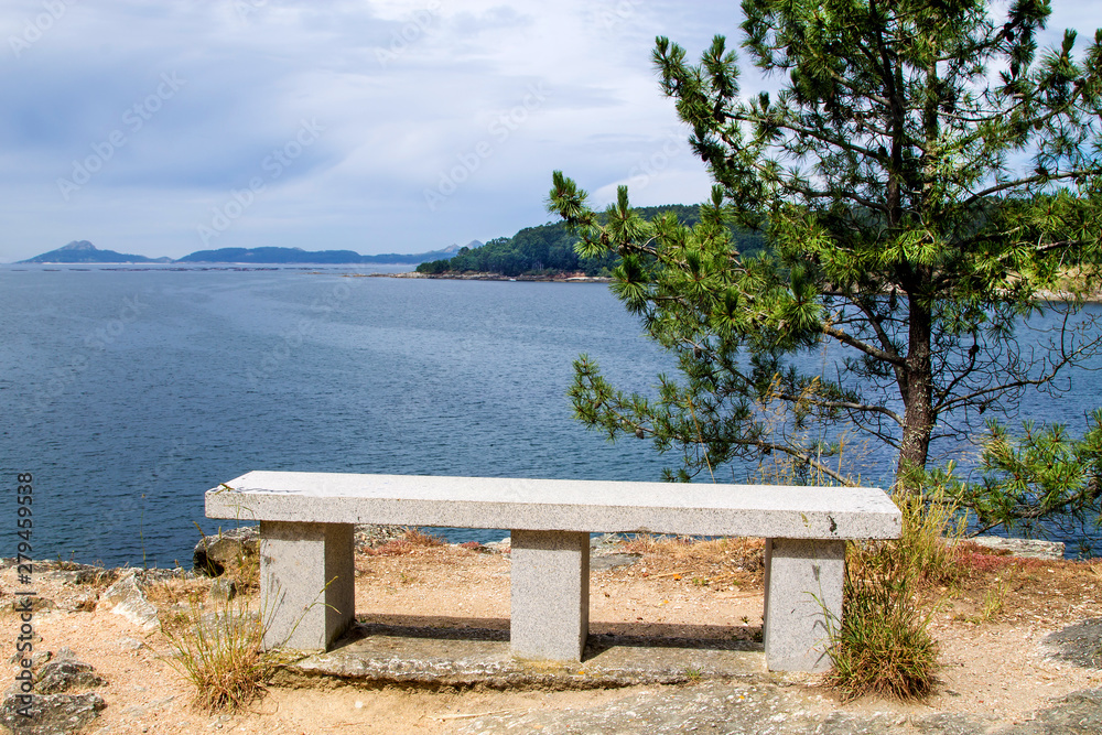 Lonely stone bench with views of the Cies de Galicia islands, Spain Lonely stone bench with views of the Cies de Galicia islands, Spain