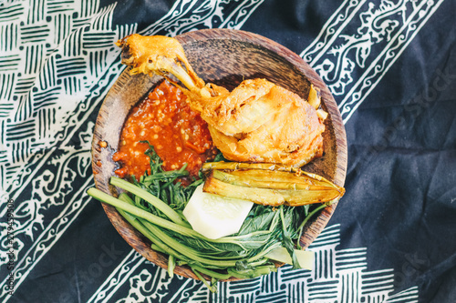 Nasi Tempong or Sego Tempong, traditional spicy culinary food of Banyuwangi, East Java, Indonesia. Similar with pecel but more spicy. mixed from rice, sambal chilli, vegetable, tofu, tempeh, and side  photo