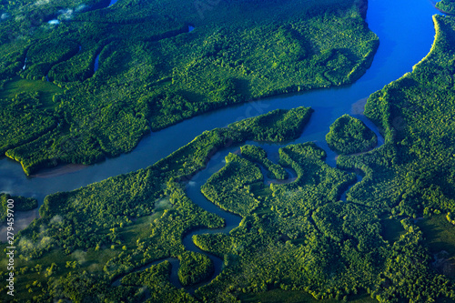 River in tropic Costa Rica, Corcovado NP. Lakes and rivers, view from airplane. Green grass in Central America. Trees with water in rainy season. Photo from air.