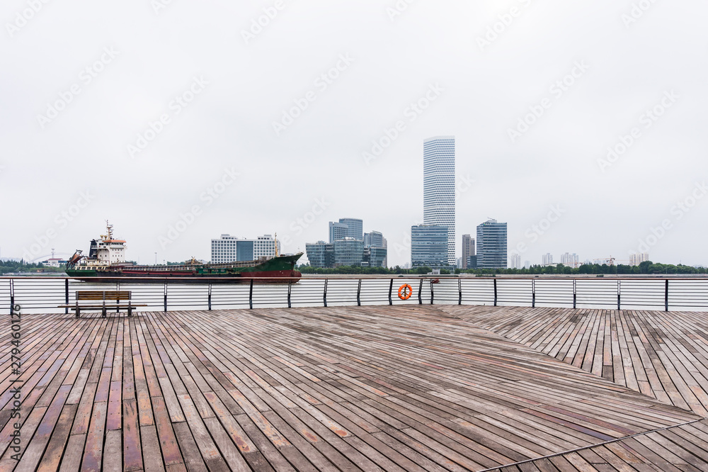 A cargo ship and surrounding buildings parked on the Huangpu River in Shanghai