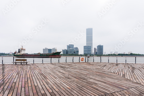 A cargo ship and surrounding buildings parked on the Huangpu River in Shanghai