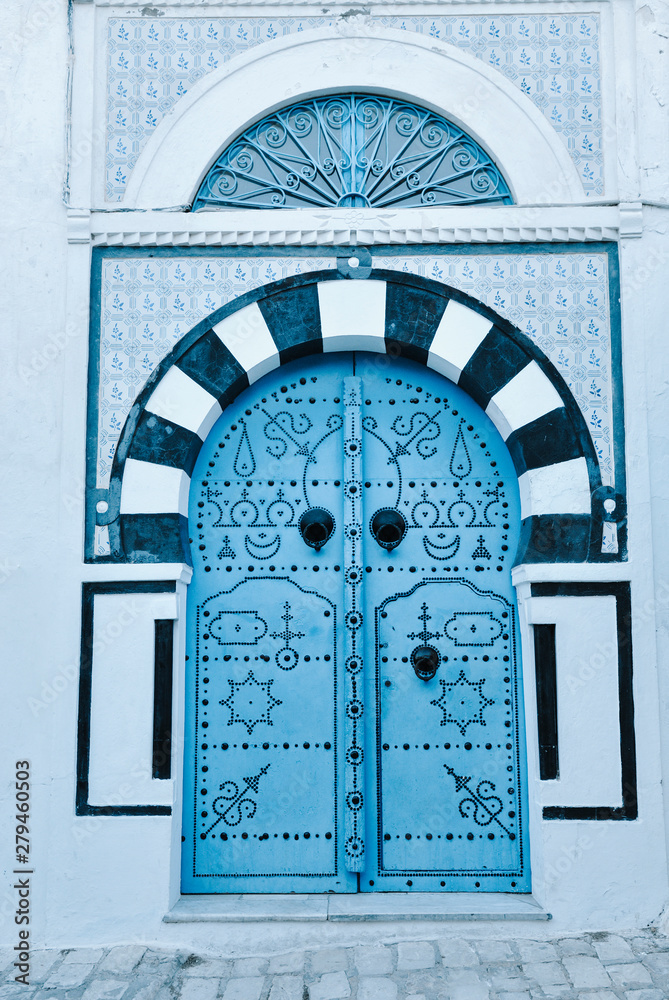 Naklejka premium Arched Doorway with Blue Studded Door, Africa, North Africa, Tunisia, Sidi Bou Said