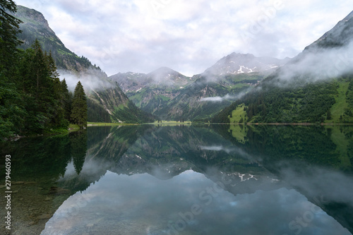 Morning view of lake vilsalpsee in tannheim tannheimer tal austria alps with mist low clouds