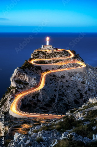 Cap Formentor lighthouse in blue hour evening light with car light streaks, mallorca, spain 