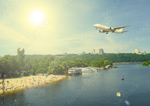 The sun over the plane, the river and the forest in the city.