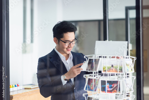 businessman choosing the postcard