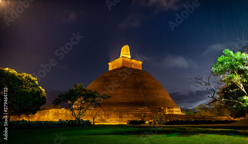 Stupa Jetavanaramaya in beams of night illumination. photo