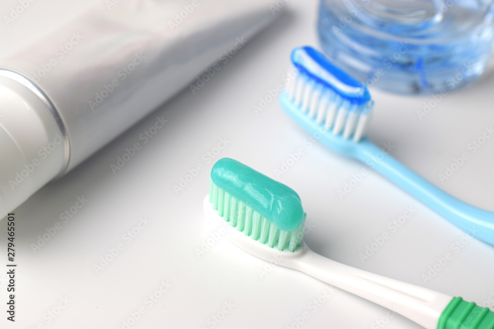 Toothbrush and toothpaste on white table in bathroom Toothbrush and toothpaste on white table in bathroom