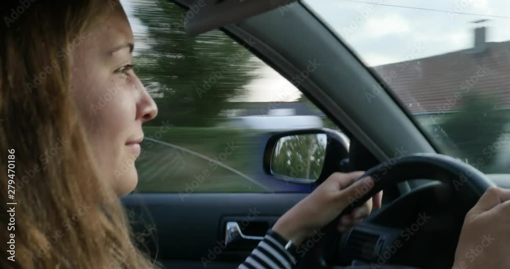 pretty young girl driving a car