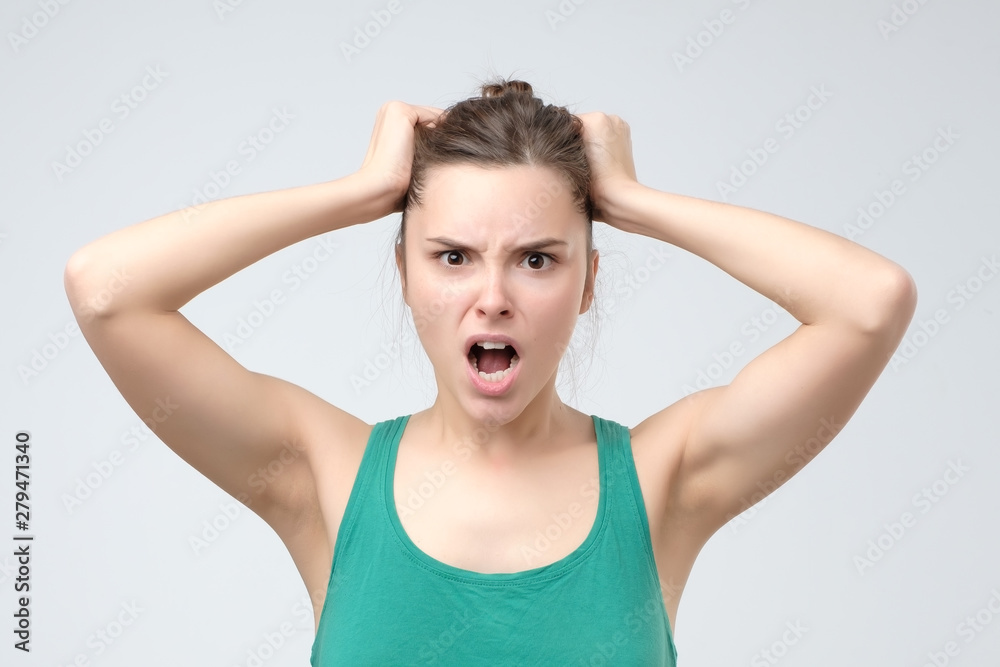 Furious european angry woman screaming with rage and frustration Furious european angry woman screaming with rage and frustration