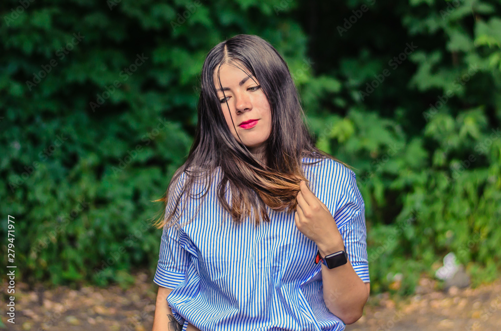 Portrait of a beautiful brunette in a blue blouse Portrait of a beautiful brunette in a blue blouse