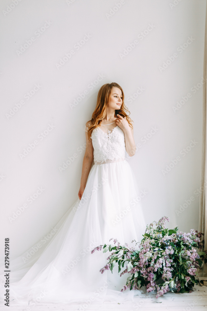 Wedding in European style. Stylish trendy bride in the Studio with a bouquet of lilacs. Wedding in European style. Stylish trendy bride in the Studio with a bouquet of lilacs.