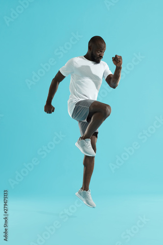 Workout. Sports man exercising, running on spot, cardio training