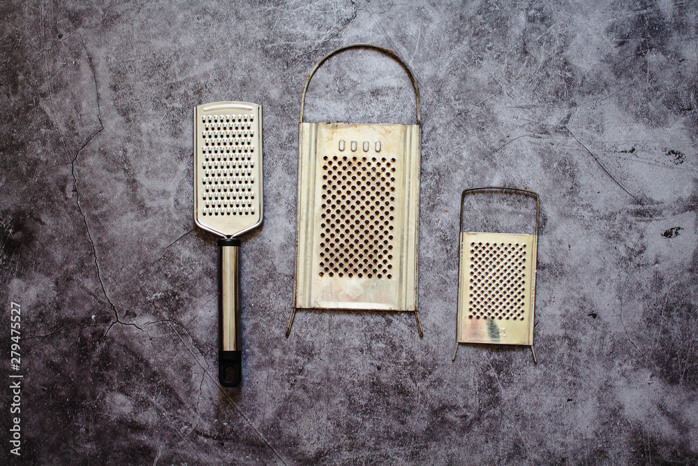 Fototapeta premium Metal graters on a gray background..Horizontal