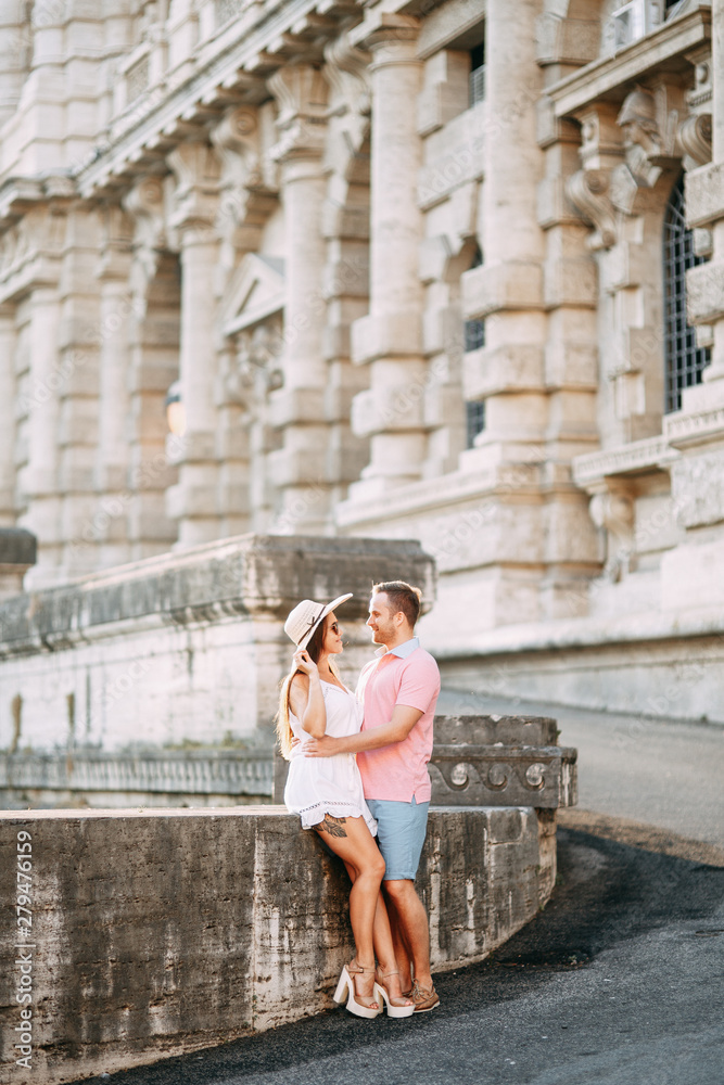 Happy couple at dawn strolling in Italy. Morning summer photo shoot in Rome.