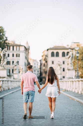 Happy couple at dawn strolling in Italy. Morning summer photo shoot in Rome.
