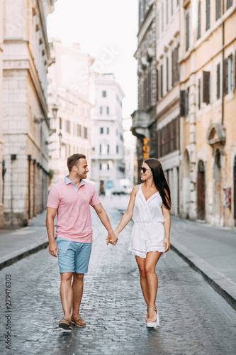 Happy couple at dawn strolling in Italy. Morning summer photo shoot in Rome. © pavelvozmischev