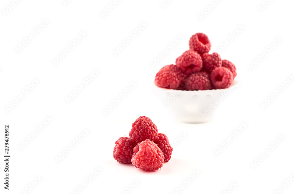 Red raspberry berries on a saucer isolated on a white background. Red raspberry berries on a saucer isolated on a white background.