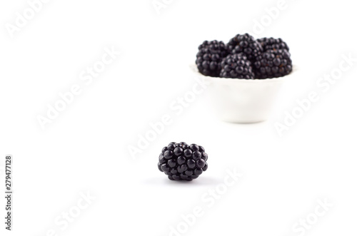Blackberries berries on a saucer isolated on a white background.