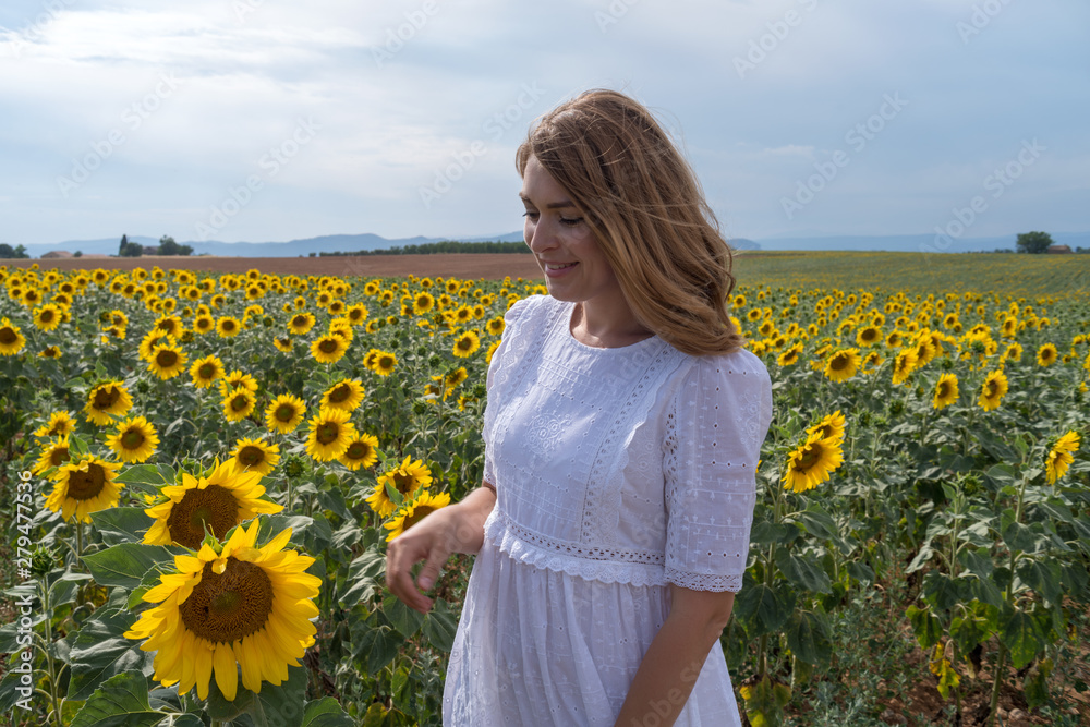 Woman in a sunflower field, Provence, France Woman in a sunflower field, Provence, France