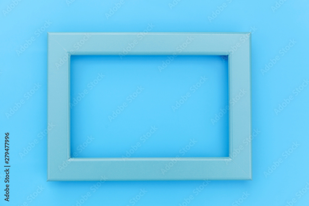 Simply design with empty blue frame isolated on blue pastel colorful background. Top view, flat lay, copy space, mock up. Minimal concept Simply design with empty blue frame isolated on blue pastel colorful background. Top view, flat lay, copy space, mock up. Minimal concept
