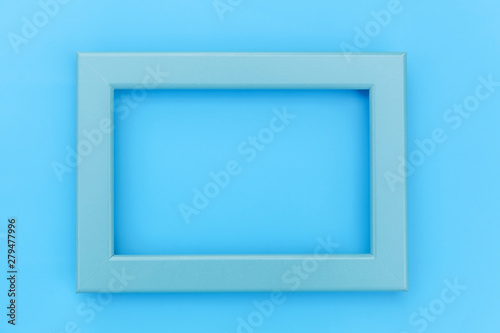 Simply design with empty blue frame isolated on blue pastel colorful background. Top view  flat lay  copy space  mock up. Minimal concept