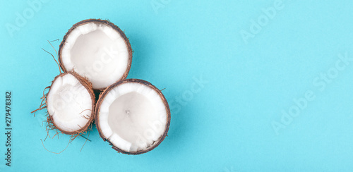 three coconut halves on a blue background, coconut panoramic mock-up
