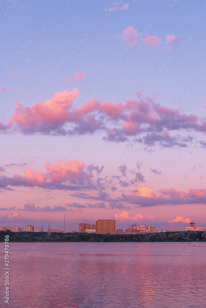 Pink sunset in the park Strogino. The picturesque bridge and clouds. Stroginsky backwater