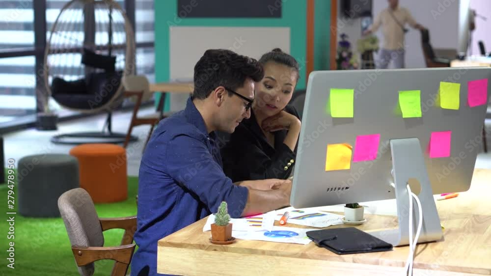 group of creative designers brainstorming together wiht computer in the meeting room . Business man and young asian woman presenting to colleagues .teamwork conference. discussing new plan group of creative designers brainstorming together wiht computer in the meeting room . Business man and young asian woman presenting to colleagues .teamwork conference. discussing new plan