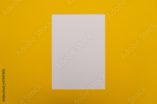 Blank white paper sheet on orange background. Layout for business, posters and banners.