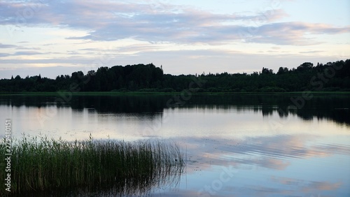 Fototapeta Naklejka Na Ścianę i Meble -  sunset over lake by forest and cloudy sky