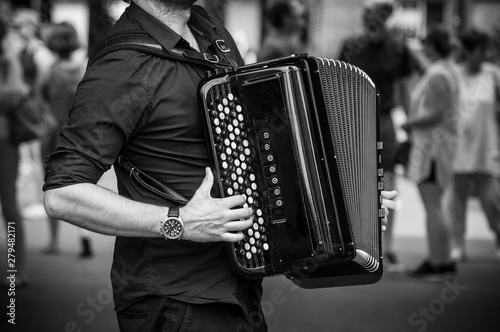closeup of hands of accordionist playing accordion in the street photo