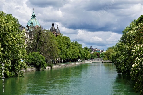 The Isar river in Munich with St Luke's church and chestnut trees photo