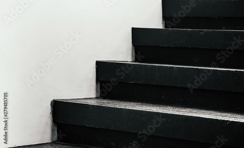 Black stairway steps with white wall - dark shadow monotone image