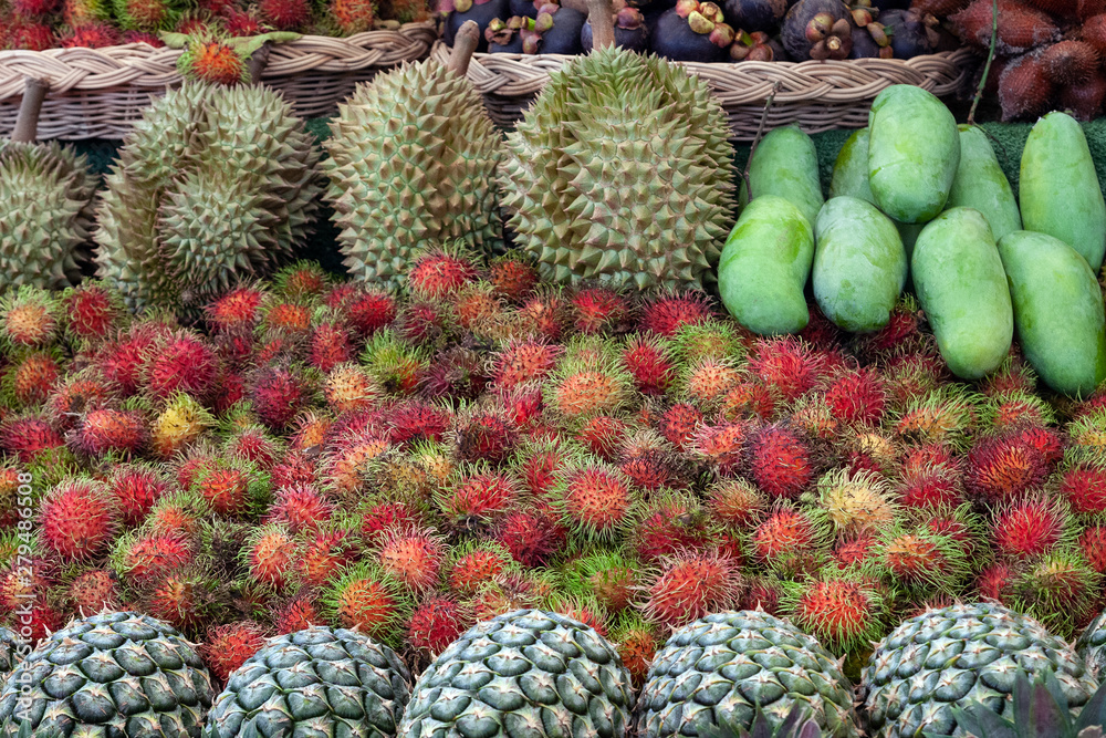 Fototapeta premium Stack of fruits that are lined up with rambutan, mango, durian, pineapple.