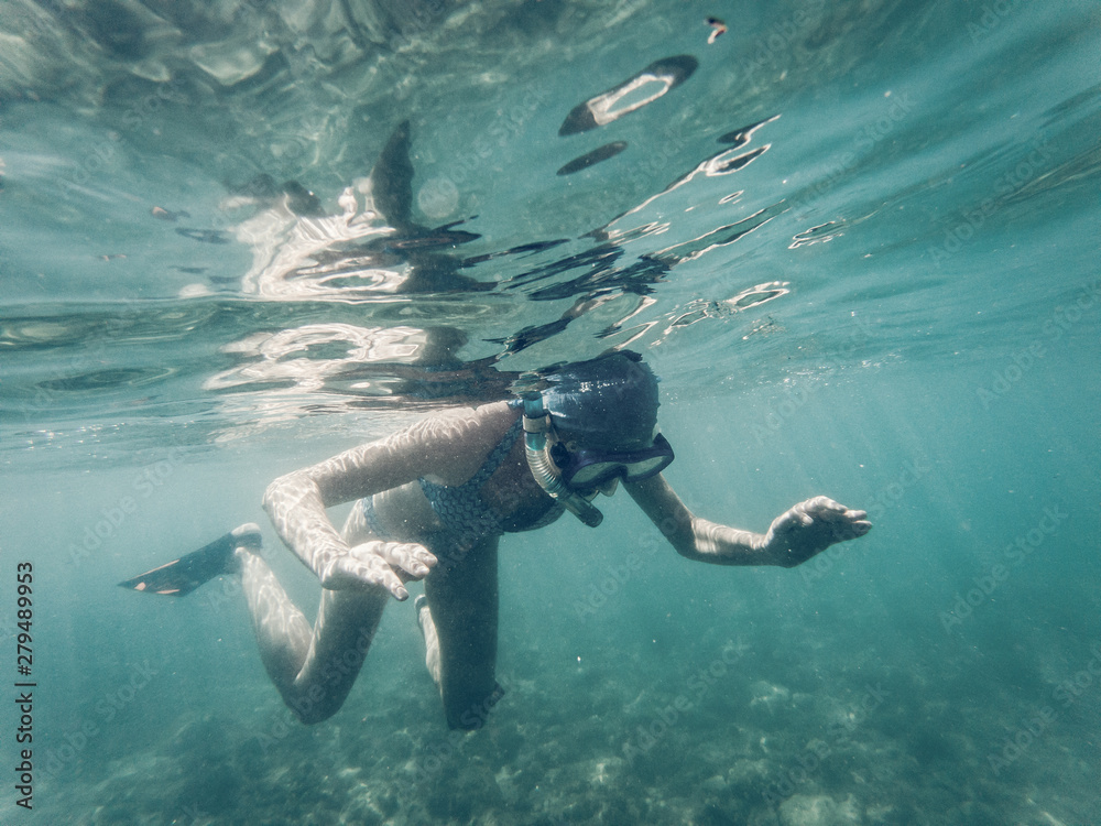 woman snorkeling in clear tropical waters - active holiday