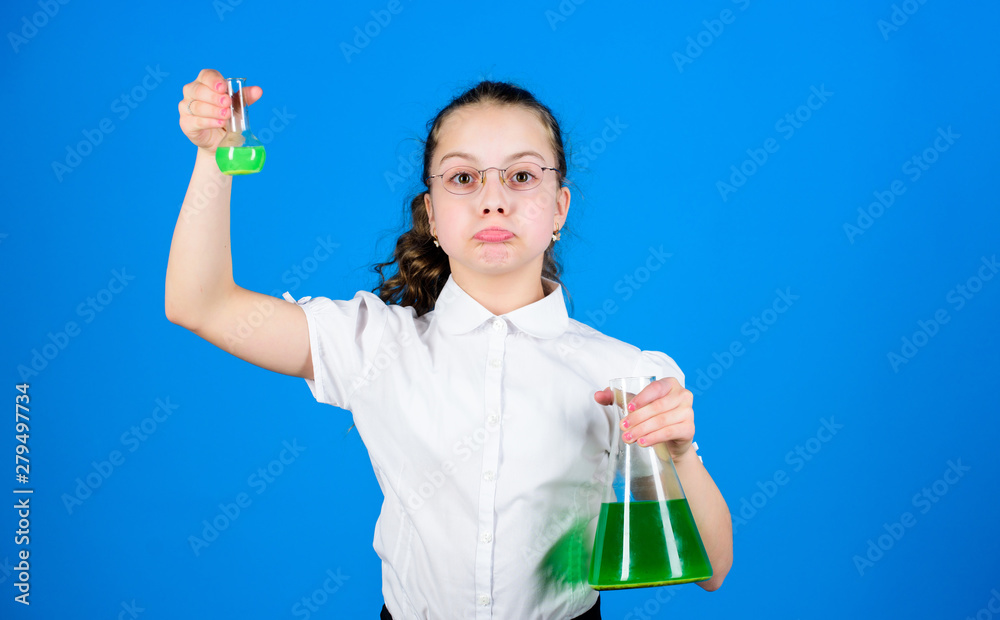 Childhood and upbringing. Knowledge and information. Experimenting a bit. Small kid study. Education concept. Chemistry fun. Basic knowledge. Knowledge day. Schoolgirl with chemical liquids Childhood and upbringing. Knowledge and information. Experimenting a bit. Small kid study. Education concept. Chemistry fun. Basic knowledge. Knowledge day. Schoolgirl with chemical liquids