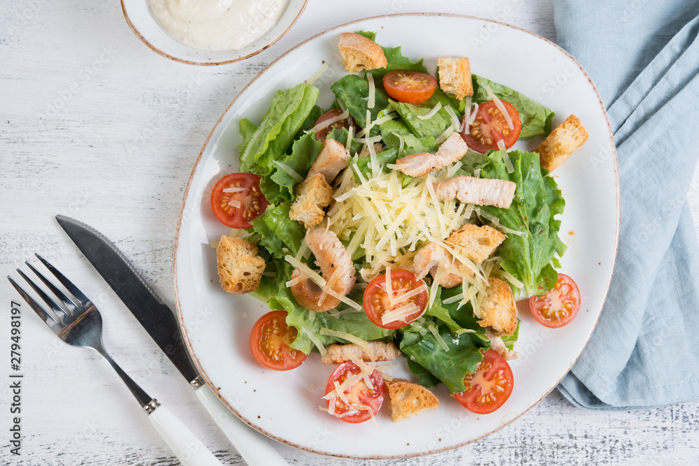 Traditional Italian Caesar salad with chicken, tomatoes and Parmesan Traditional Italian Caesar salad with chicken, tomatoes and Parmesan