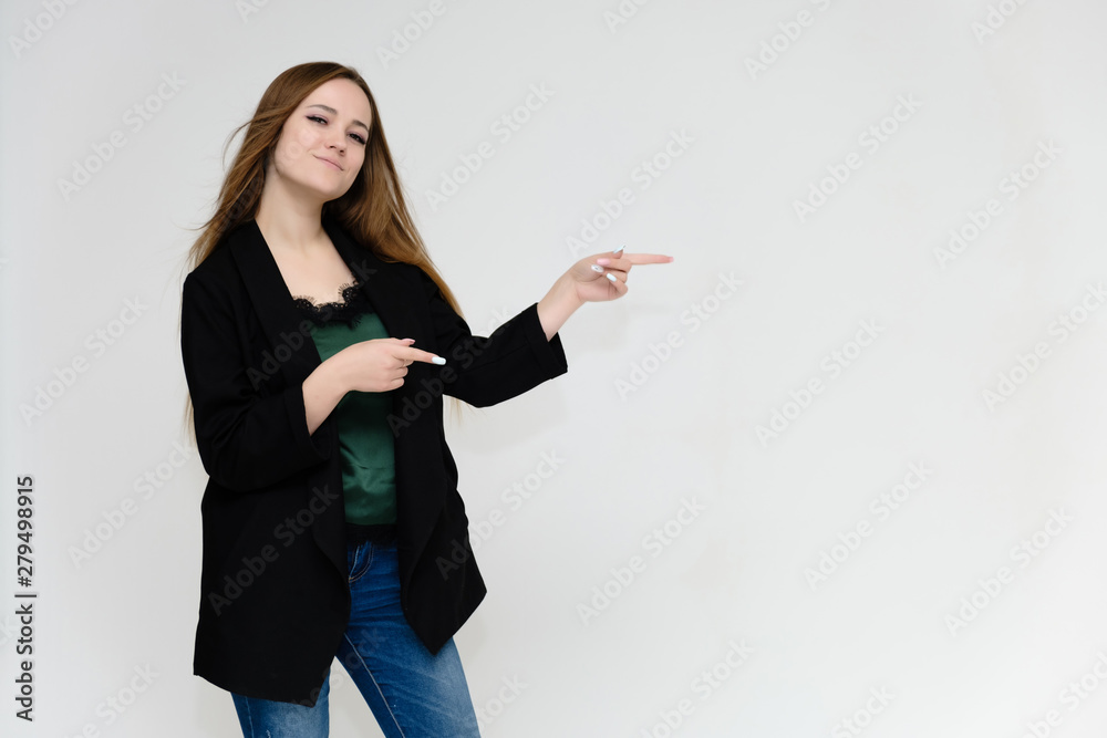 Concept portrait above the knee of a pretty girl, a young woman with long beautiful brown hair and a black jacket and blue jeans on a white background. In studio in different poses showing emotions. Concept portrait above the knee of a pretty girl, a young woman with long beautiful brown hair and a black jacket and blue jeans on a white background. In studio in different poses showing emotions.