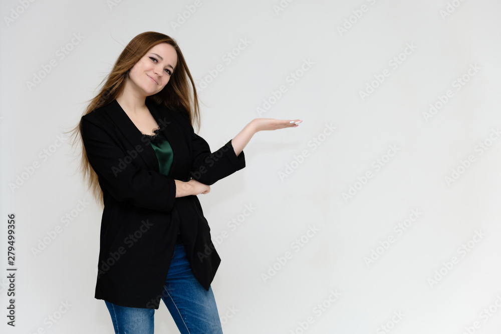 Concept portrait above the knee of a pretty girl, a young woman with long beautiful brown hair and a black jacket and blue jeans on a white background. In studio in different poses showing emotions. Concept portrait above the knee of a pretty girl, a young woman with long beautiful brown hair and a black jacket and blue jeans on a white background. In studio in different poses showing emotions.