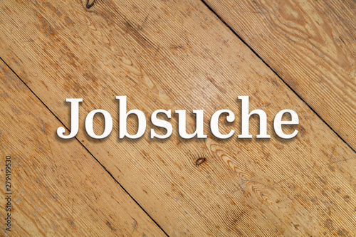 `Jobsuche` white text on a wooden background. Translation: `Job search` photo