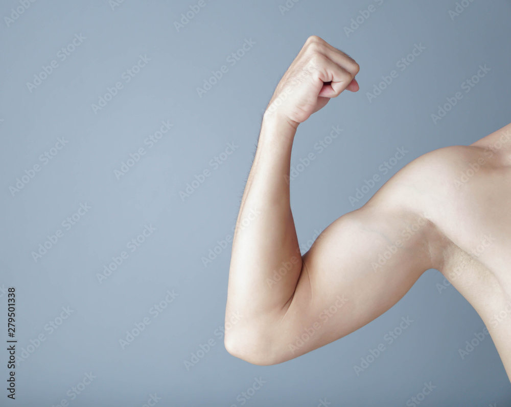 Man arm with muscle on grey background, health care and medical concept Man arm with muscle on grey background, health care and medical concept