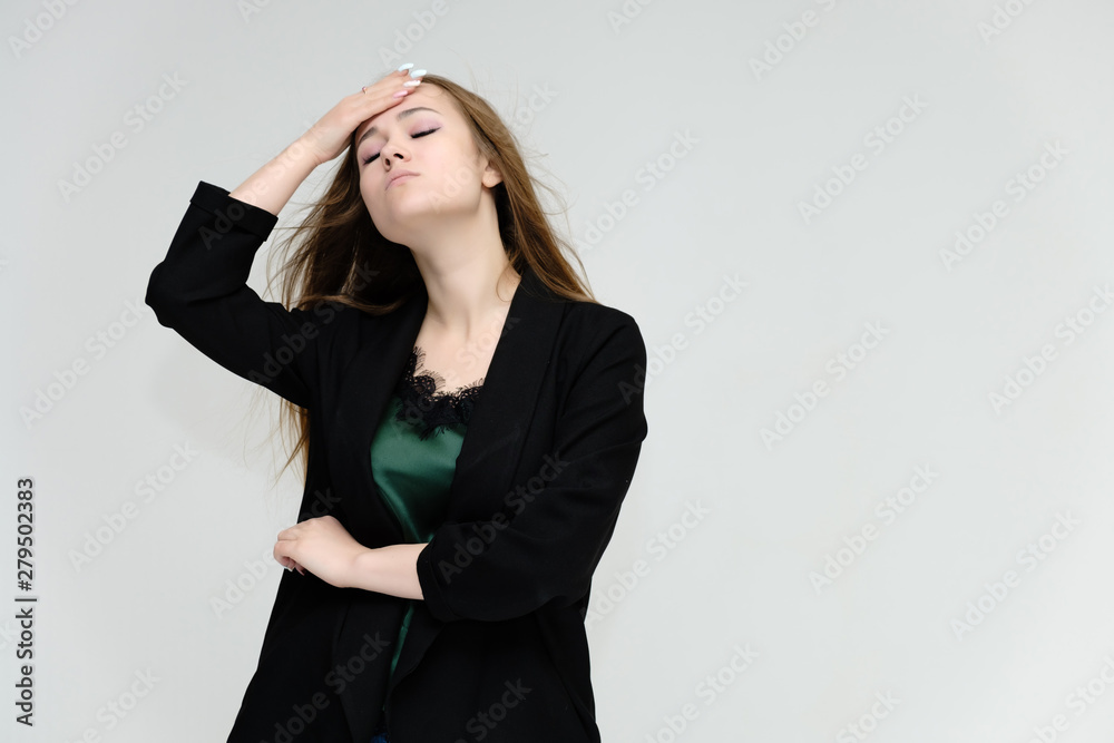 Concept portrait for the waist of a pretty girl, a young woman with long beautiful brown hair and a black jacket and blue jeans on a white background. In studio in different poses showing emotions. Concept portrait for the waist of a pretty girl, a young woman with long beautiful brown hair and a black jacket and blue jeans on a white background. In studio in different poses showing emotions.