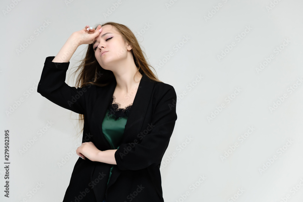 Concept portrait for the waist of a pretty girl, a young woman with long beautiful brown hair and a black jacket and blue jeans on a white background. In studio in different poses showing emotions. Concept portrait for the waist of a pretty girl, a young woman with long beautiful brown hair and a black jacket and blue jeans on a white background. In studio in different poses showing emotions.