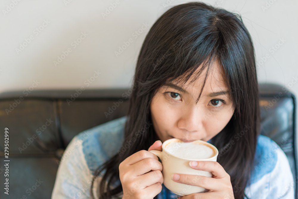 Beautiful asian women hold hot coffee cup in cafe Beautiful asian women hold hot coffee cup in cafe