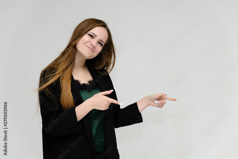 Concept portrait for the waist of a pretty girl, a young woman with long beautiful brown hair and a black jacket and blue jeans on a white background. In studio in different poses showing emotions. Concept portrait for the waist of a pretty girl, a young woman with long beautiful brown hair and a black jacket and blue jeans on a white background. In studio in different poses showing emotions.