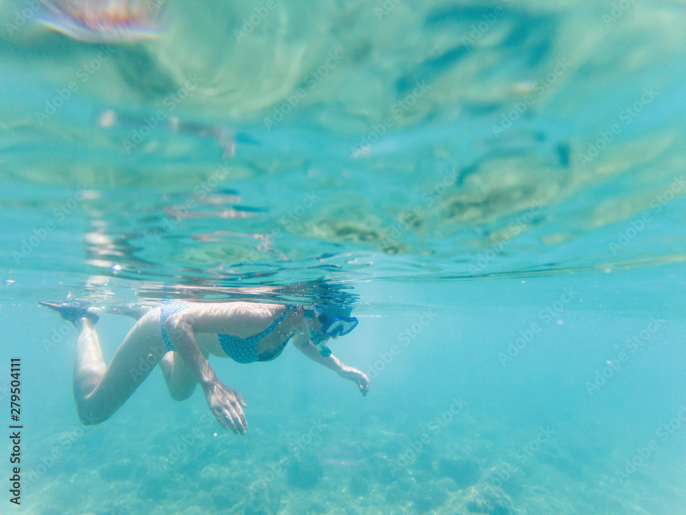 woman snorkeling in clear tropical waters - active holiday