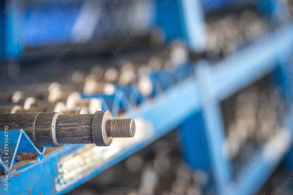 Wireline or Slickline (one kind of well service operation in oil field)  general downhole tools are orderly keeping on metal shelve in the store.  Selected focus on connection thread. Stock Photo