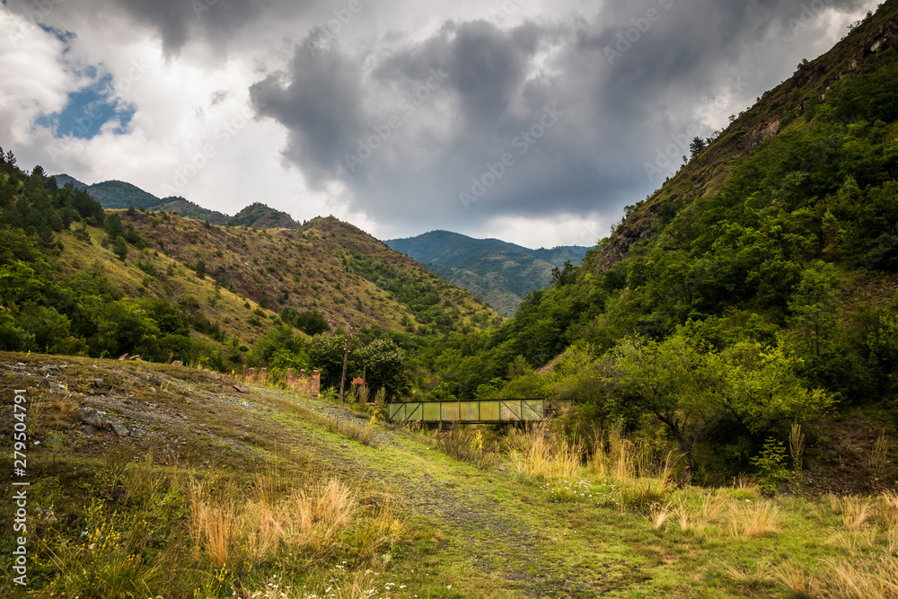 Mountain and forest, cloudy day with dark clouds. Near the Ibar river and Maglic castle in Serbia Mountain and forest, cloudy day with dark clouds. Near the Ibar river and Maglic castle in Serbia
