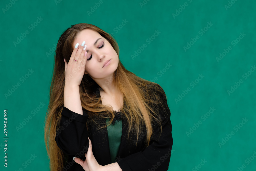 Concept close-up portrait of a pretty girl, a young woman with long beautiful brown hair and in a black jacket on a green background. In the studio in different poses showing emotions. Concept close-up portrait of a pretty girl, a young woman with long beautiful brown hair and in a black jacket on a green background. In the studio in different poses showing emotions.